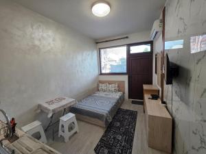 a bedroom with a bed and a table and a window at relax in Plovdiv