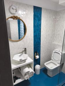a small bathroom with a toilet and a mirror at Navis Mamaia Nord in Mamaia Sat/Năvodari +39 photos