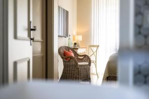 a living room with a chair with a red pillow at The Little Guesthouse in Salzburg +72 photos