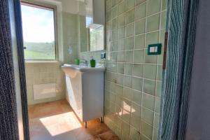 a bathroom with a sink and a window at Country House Vignola Mare in Aglientu +176 photos