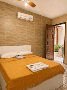 a bedroom with a bed with towels on it at Hotel Pousada Casuarinas in Recife