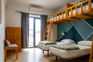 two beds in a room with a bunk bed at WOT Nomad Social in Lisbon +100 photos