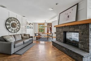 a living room with a couch and a fireplace at Rundle Cliffs Lodge by Canmore Premier in Canmore