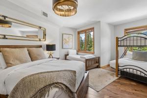 a bedroom with two beds and a window at Rundle Cliffs Lodge by Canmore Premier in Canmore