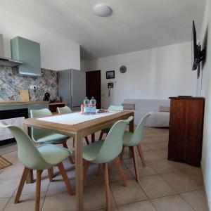 a dining room with a table and chairs at Pauli's apartment in Valledoria