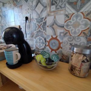 a counter with a coffee maker and a bowl of eggs at Pauli's apartment in Valledoria
