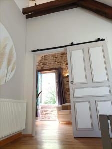 a room with a white door and a window at Ted et Breakfast in Corrèze