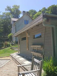 a small house with a bench in front of it at Ted et Breakfast in Corrèze