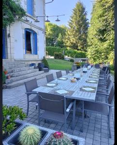a long table in a yard with chairs and cactus at Ted et Breakfast in Corrèze +53 photos