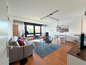 a living room with a couch and a table at Gemütliches App in Westerland mit Hund in Süderende