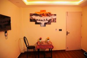 a room with a table and a painting on the wall at Hotel Kusum Palace in Kathmandu