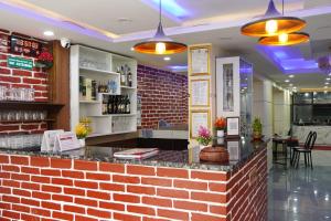 a bar in a restaurant with a brick wall at Hotel Kusum Palace in Kathmandu