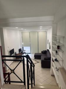 a living room with a couch and a table at Phoenix - Rise and Relax in Agia Galini
