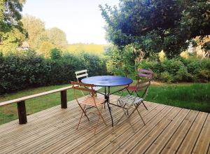 a table and two chairs on a wooden deck at Au Clères de yourte in Cléres +14 photos