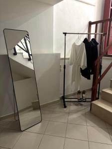 a dressing room with a mirror and a rack with clothes at Phoenix - Rise and Relax in Agia Galini +20 photos
