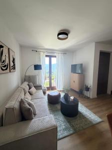 a living room with a couch and a table at Rustico Villa Antonia with seaview and pool in Bieno