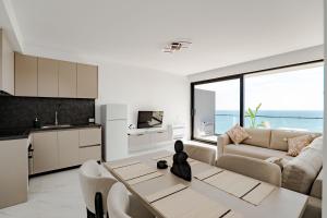 a living room with a couch and a table at SeaScape Residence in Borsh