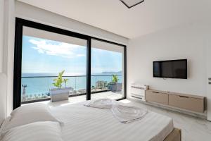 a bedroom with a large window with a view of the ocean at SeaScape Residence in Borsh