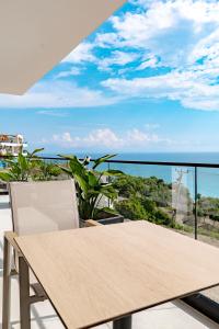 a table and chairs on a balcony with a view of the ocean at SeaScape Residence in Borsh