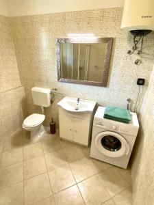 a bathroom with a washing machine and a sink at Salis in Novigrad Istria +39 photos