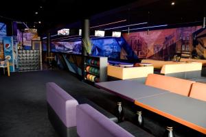 a room with a table and chairs and televisions at Złoty Łan in Nowa Sól