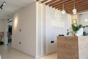 a lobby of an office with a sign on the wall at Erdeti Boutique Hotel in Sarandë