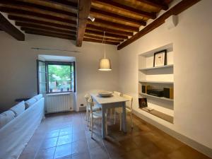 a living room with a table and a couch at Window to Bagno Vignoni in Bagno Vignoni