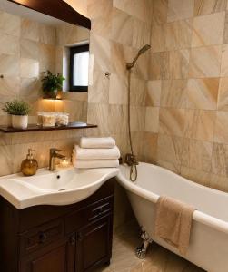 a bathroom with a tub and a sink at Casa Mediteraneana Verde in Alba Iulia +3 photos
