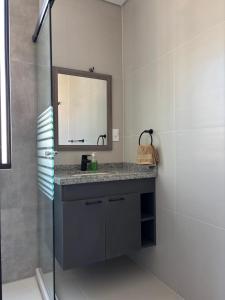 a bathroom with a sink and a mirror at Aura Exclusive - Achumani in La Paz +6 photos