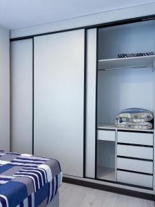 a bedroom with sliding glass doors and a bed at Aura Exclusive - Achumani in La Paz