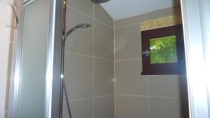 a bathroom with a shower with a television in it at Chambre D'hôtes Indépendante in Pessac +17 photos