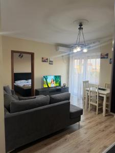 a living room with a couch and a dining room at B&B Tirane in Tirana