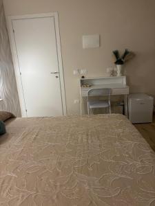 a bedroom with a bed and a desk and a door at The Superhost - Marekiaro in Crotone