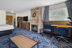 a hotel room with a bed and a fireplace at Best Western Indian Oak in Chesterton