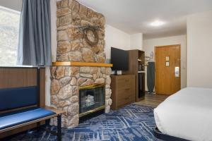 a hotel room with a fireplace and a bed at Best Western Indian Oak in Chesterton