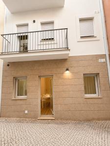 a building with a balcony on top of it at Casa Rabiosa in Nazaré