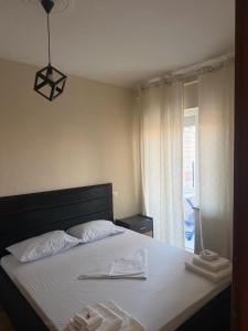 a bedroom with a bed with two towels on it at B&B Tirane in Tirana