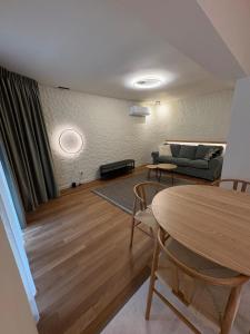 a living room with a couch and a table at City View Apartment in Râmnicu Vâlcea +6 photos