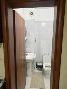 a bathroom with a toilet and a sink at B&B Tirane in Tirana +15 photos