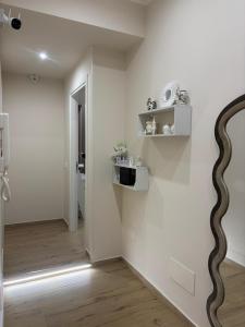 a room with white walls and a snake painted on the wall at The Superhost - Marekiaro in Crotone