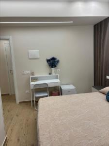 a bedroom with a bed and a desk and a sink at The Superhost - Marekiaro in Crotone +11 photos