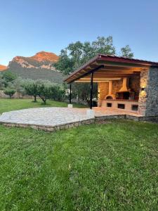 a pavilion in a field with mountains in the background at eleni's villa in Kandhíla +160 photos