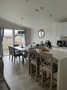 a kitchen and dining room with a table and chairs at Edmonton Lodge in Clitheroe