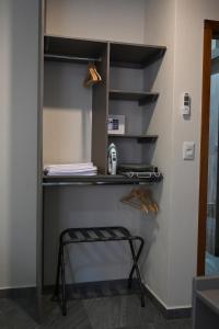 a walk in closet with a shelf and a stool at Casa Tita in Acámbaro