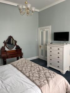 a bedroom with a bed and a mirror and a dresser at Bray Head B&B in Bray