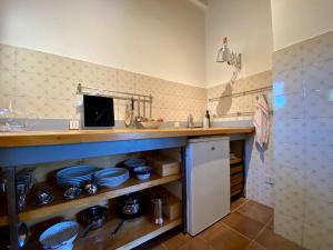 a kitchen with a counter and a sink at Window to Bagno Vignoni in Bagno Vignoni +7 photos