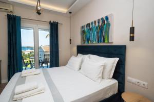 a bedroom with a bed with a view of the ocean at Panorama Hideaway in Dassia +134 photos