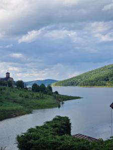 a view of a river with a building in the distance at Villa Beti in Mavrovo