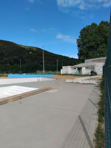 an empty parking lot next to a fence at Mobil home LE COUCOU in Le Martinet