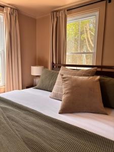 a bedroom with a large bed with a window at Hideaway Inn Maine in Camden